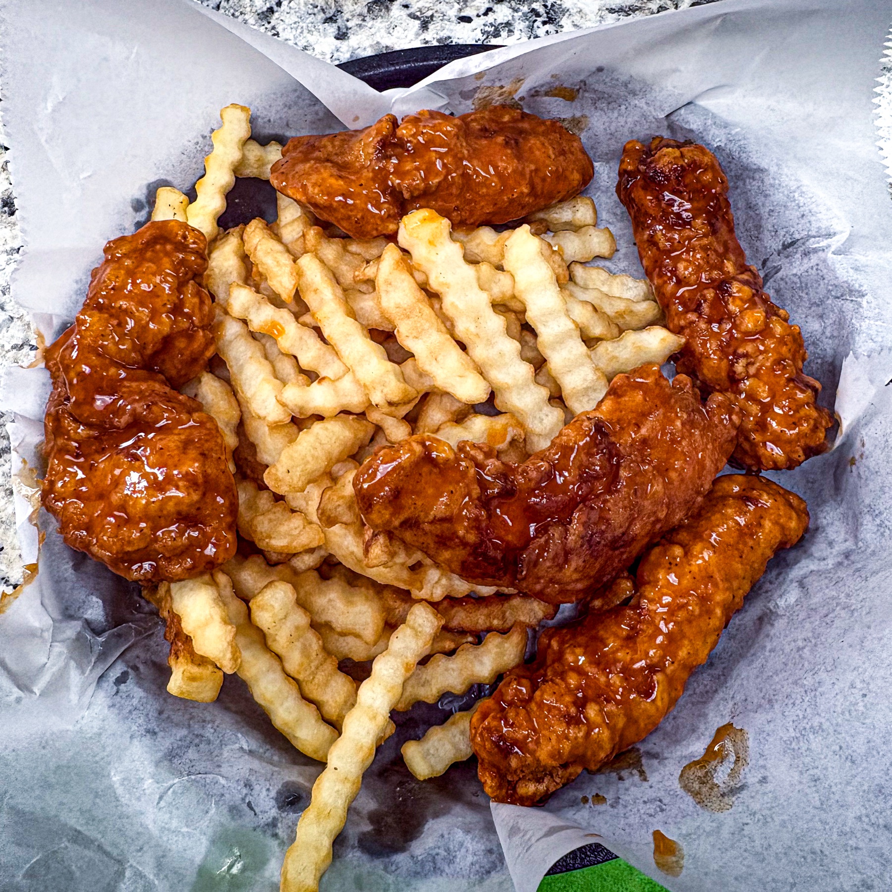Buffalo chicken tenders basket with fries at Royal Biscuit